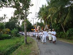 people in white suits at the ceremony