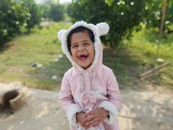 small asian girl laughing outdoor