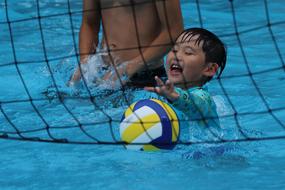 leisure with a ball in the pool water