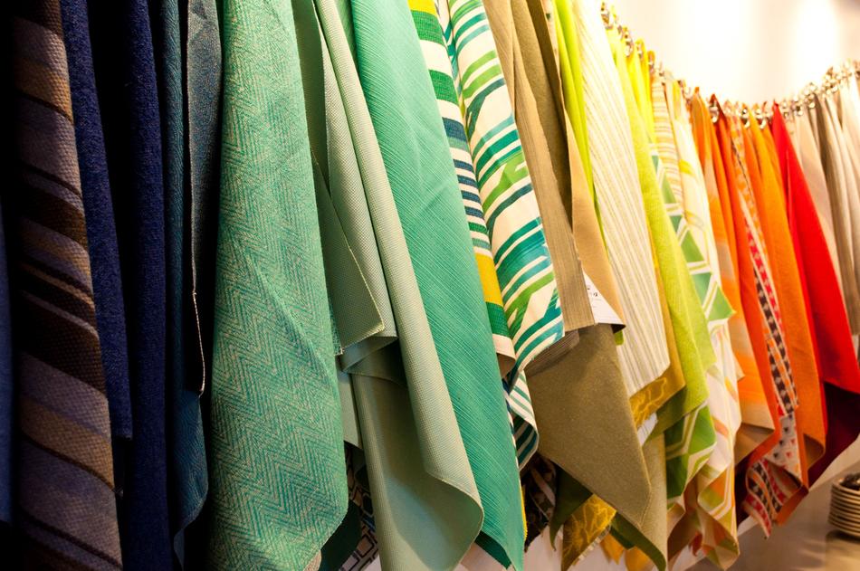 Close-up of the colorful, hanging textile pieces with patterns, in light
