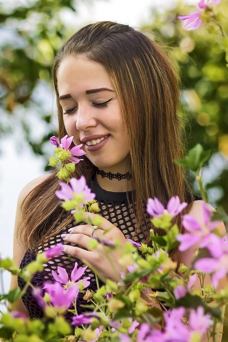 girl posing with flowers on a blurred background