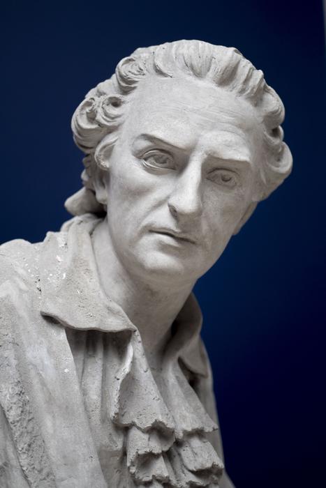 Portrait of the beautiful white man statue at blue background