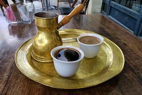 hot coffee on a golden tray