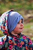 child in a jacket with a floral print