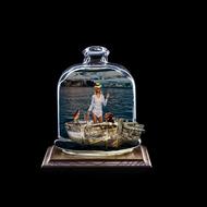 a girl with a dog in a boat under a glass dome