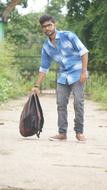 man with a backpack on the road in India