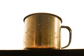 gold mug with water drops