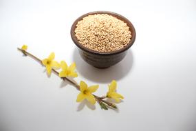 flowers near the plate of grains