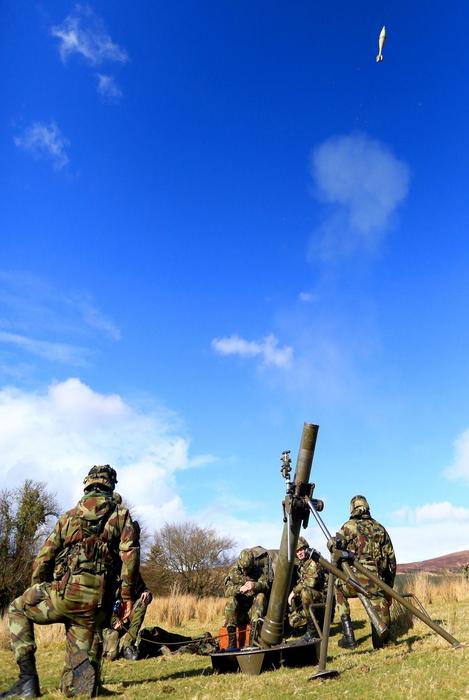 soldiers shooting from mortar launcher