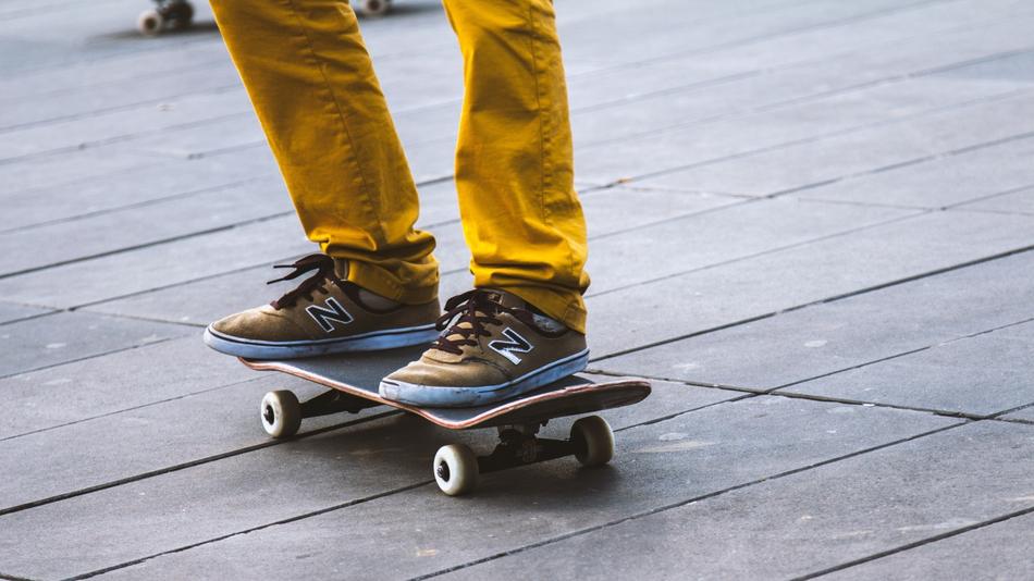 Guy in yellow pants, skateboarding on the wooden surface