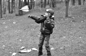 child boy plays with Paper Plane