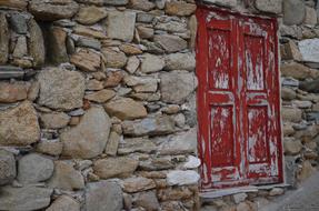 Mykonos Red Door in stone wall