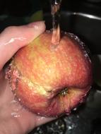 Washing an apple under water