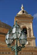 vintage street Lantern in front of historical bell tower