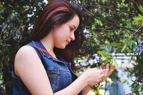 girl is looking at a tree branch