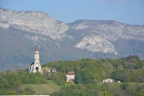 a church in green trees and mountains