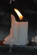 white wax candle in the night