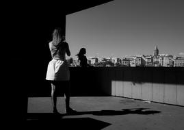 a girl in a dress taking a picture