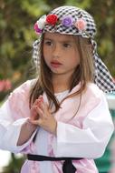 Cute Latin girl in costume with colorful flowers