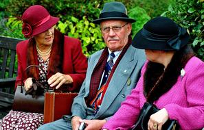 a man and two ladies on a bench