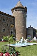 fountain in front of a medieval castle