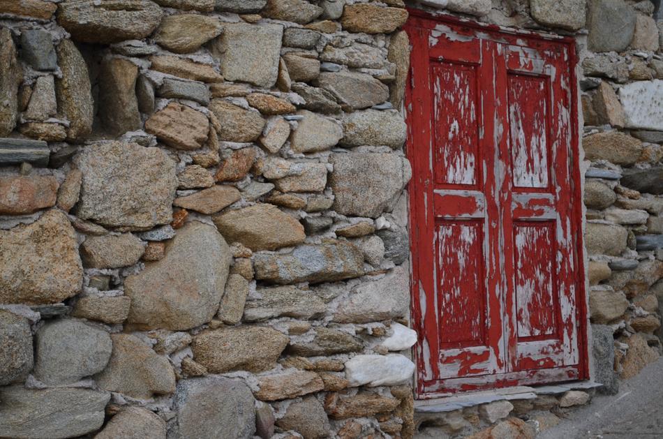 Mykonos Red Door in stone wall