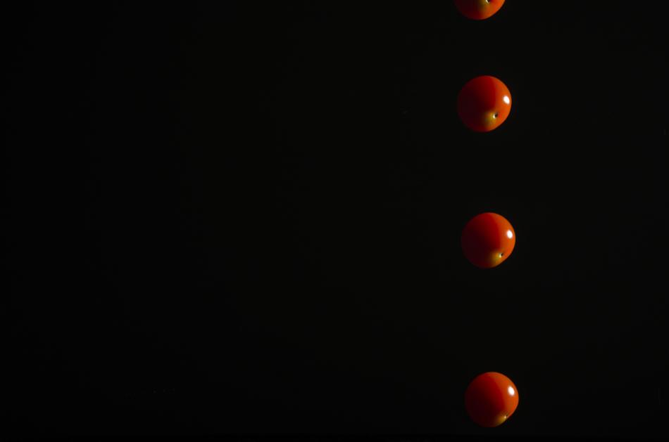 falling tomatoes on a black background
