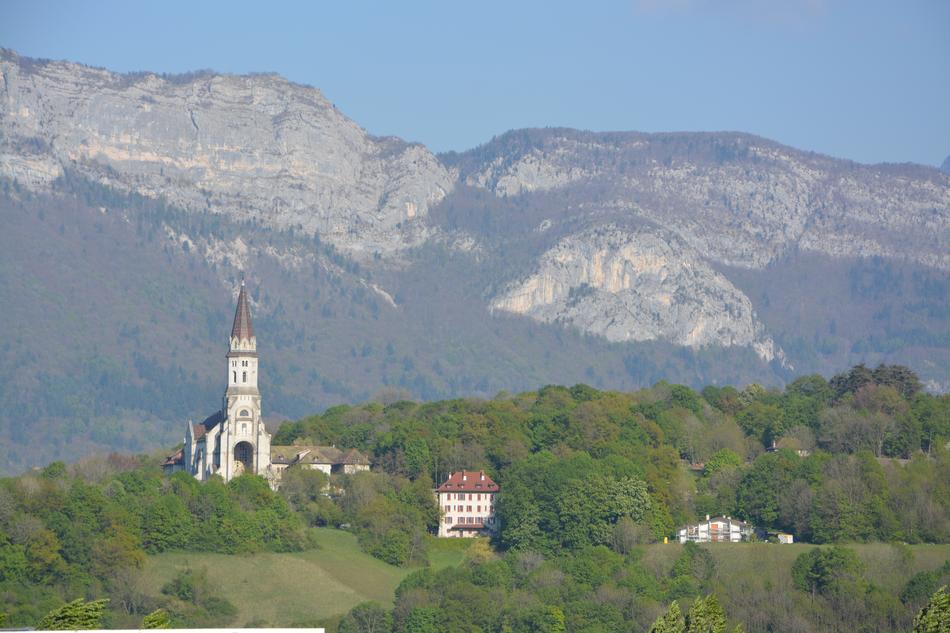 a church in green trees and mountains