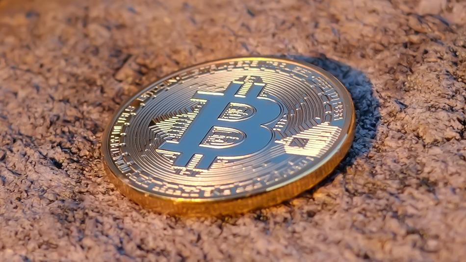 bitcoin on brown stone