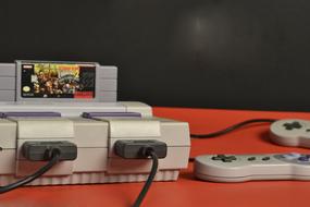 game console with two joysticks and a cartridge