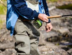 fisherman hand fishing rod macro blur