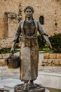 stone sculpture of a girl with a basket