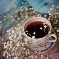 hot coffee on a background of white flowers