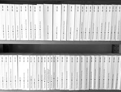 Close-up of the white and black books on the bookshelves, in light