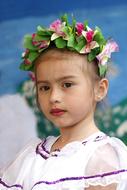 Portrait of the cute Latin girl in colorful wreath