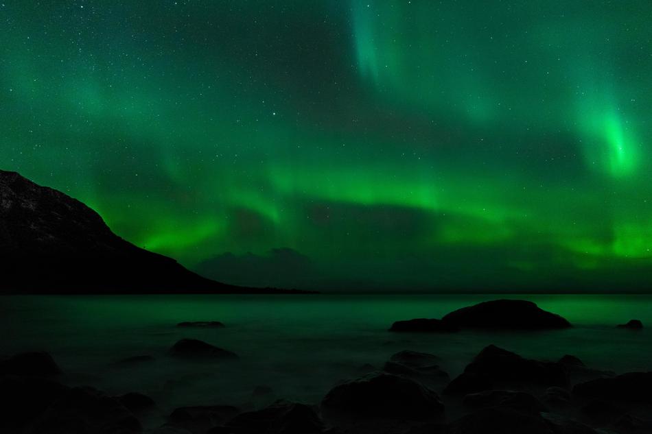 green sky with rocks in the fog