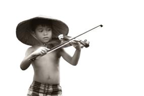 photo of a vietnamese boy with a violin