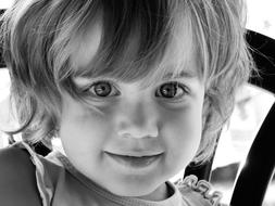 Black and white portrait of the cute child with shiny eye