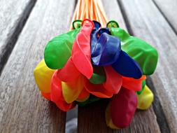 deflated balloons on a stick
