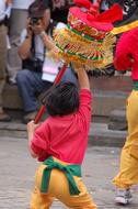 People in colorful costumes, dancing at the festival