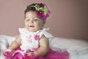 Portrait of the cute baby in colorful clothing and decorations