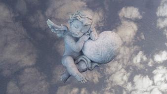 statue heart clouds view