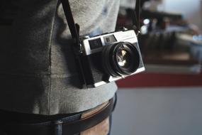 vintage camera hanging on shoulder close up