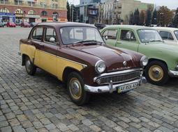 antique cars in a row in the city square