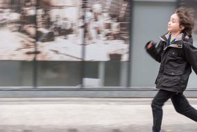 running boy in black jacket