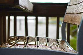 wooden bench in raindrops