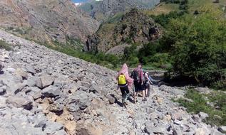 hikers walking on rocks in the mountains