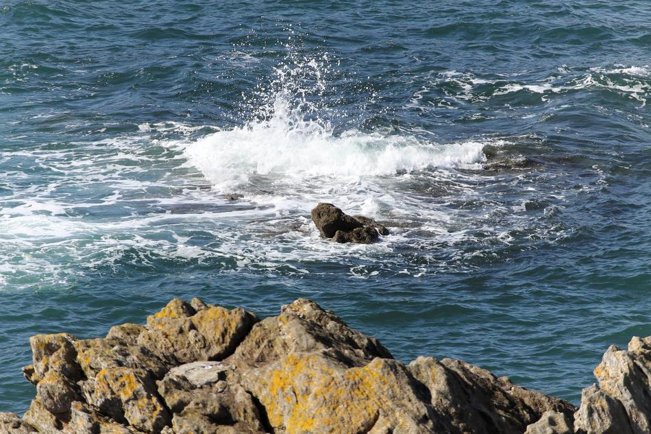 splashing water in the sea and rocks