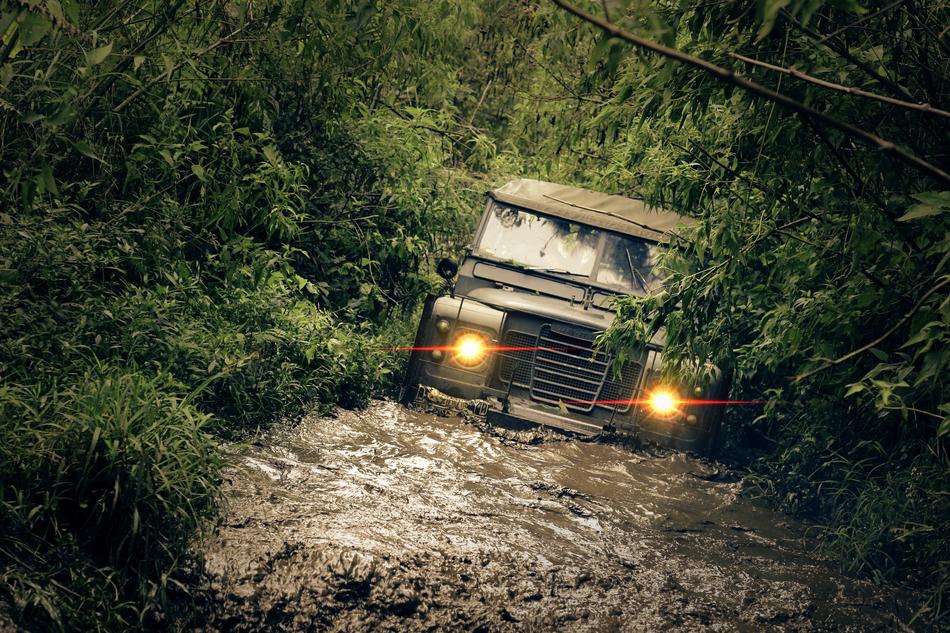 an old car in a puddle and mud