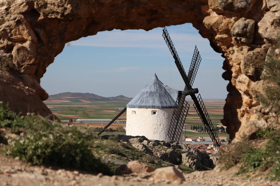white mill in stone arch landscape